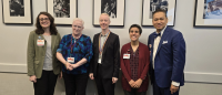 Five presenting speakers at a conference